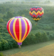 2 Hot air balloons in flight over fog in Atlanta