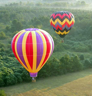 2 Hot air balloons in flight over fog in Atlanta