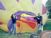 Mauricio and Maria hold mouth of ballon open